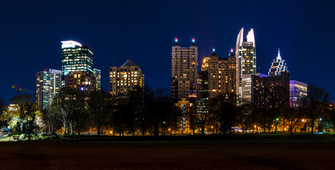 Dusk view of illuminated skyscrapers of Midtown Atlanta from the Piedmont Park, USA
