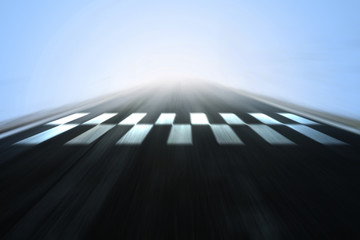 Abstract blurred race asphalt road with finish and start line pattern background.