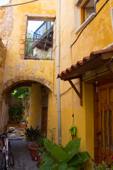 Fototapeta na wymiar Yellow yard on street in greek town Chania. Crete