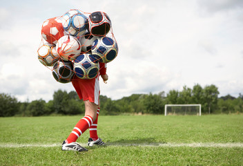 Footballer struggles with bag of balls