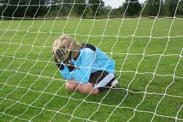 Goalkeeper with head in hands