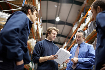 Manager and workers in warehouse