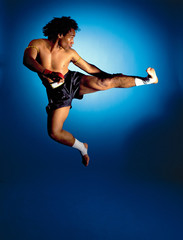 Fototapeta na wymiar man doing jumping side kick