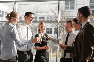 Happy business executives with champagne