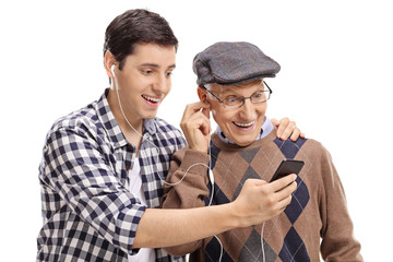 Grandson listening to music on a phone with his grandfather