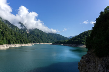 Fototapeta na wymiar Landscape of hills,Lake and blue sky in Kurobe dam, tateyama, JAPAN.