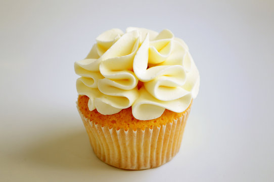 Cupcake with cream on white background. Picture for a menu or a confectionery catalog.