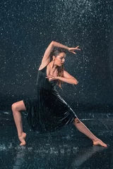 Foto op Plexiglas The young beautiful modern dancer dancing under water drops © master1305