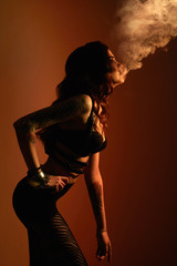 Obraz na płótnie Canvas Young sexy woman in underwear smokes.