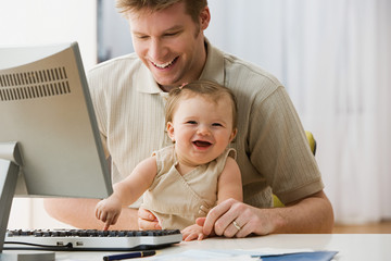 Fototapeta na wymiar Father and daughter using computer