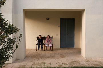 Girl and boy sitting on bench