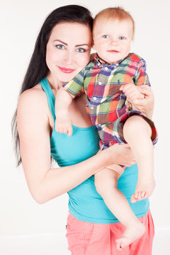 mom playing with young son colored clothing