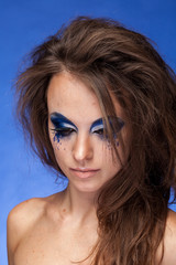 Woman with blue creative make up in studio photo
