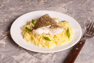 fish with rice on a white plate