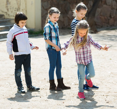 Kids Playing In Hopscotch Game