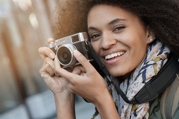 Trendy girl in New York City taking pictures with camera