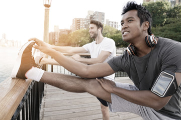 Asian guy stretching out after exercising