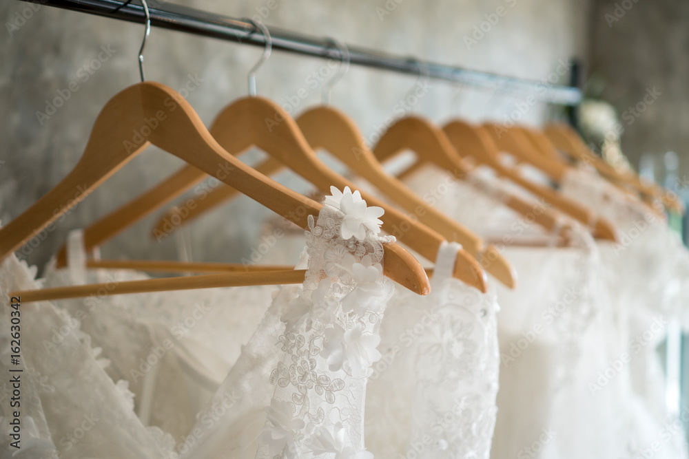 Wall mural beautiful wedding dresses on a hanger