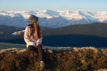 Fototapeta na wymiar Happy girl enjoying sunrise in the mountains after morning hike copyspace nature travel tourism sport freedom happiness achieving relaxation recreation