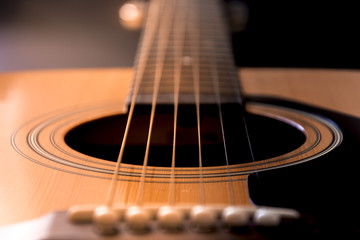 Detail of guitar. View on guitar strings. Wooden musical instrument.