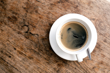 Coffee cup top view on wooden table background