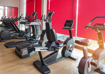 Fototapeta na wymiar stationary bikes and equipment health exercise for bodybuilding in gym modern fitness center room