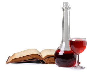 Glass of wine and book on white background