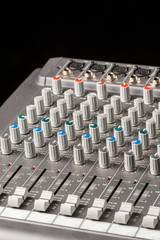 Fototapeta premium Audio mixing console with sliders and knobs on the channels.