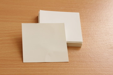 Blank Trifold white template paper on wood background with soft shadows. Ready for your design