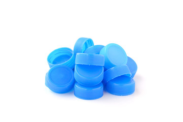 pile of blue plastic bottle cap on white background