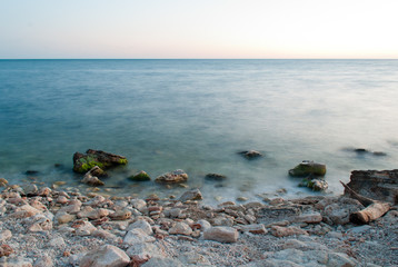 Beautiful sunset over the sea and rocky shore