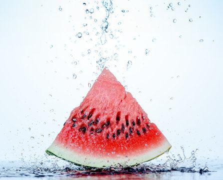 Fresh red watermelon slice with splash and drops of water