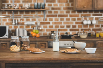 Fototapeta na wymiar Milk with fresh homemade waffles and croissants on kitchen table
