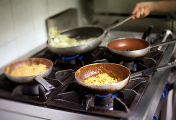 Italian pasta and sauces cooking on a burner