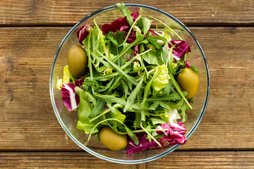 Fresh green salad in glass bowl.