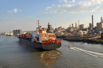 A large merchant ship container vessel in coastal waters of Savannah USA. A merchant ship is moving...