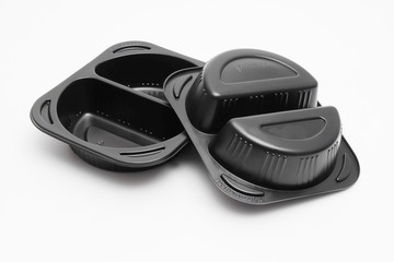 Fototapeta premium Black microwaveable plastic food containers on white background