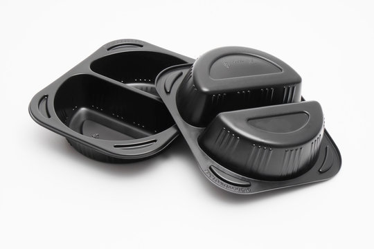 Black microwaveable plastic food containers on white background