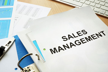 Folder and documents with title sales management.
