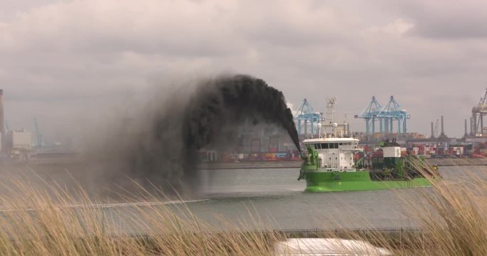 dredging operation of hopper dredger Reynaert, rainbowing black mud when the deepening of Alexia Haven, Maasvlakte II  ROTTERDAM SEAPORT - MAY 2017