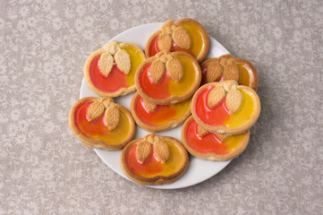 Cookies in the shape of apple with marmalade on a plate