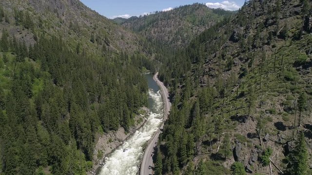 Helicopter Aerial of Scenic Pacific Northwest River by Mountain Highway in Washington State