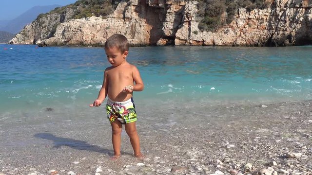 4K Kid posing against stunning sea view