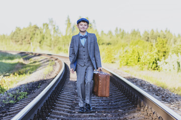 the boy waits for the train on the track