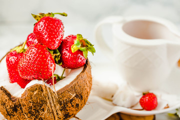 Fresh strawberry on coconut cup. Marble background.Healthy lifestyle and diet food concept.