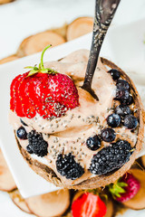 Chocolate ice cream with berries on coconut cup.Summer food and healthy dessert concept.