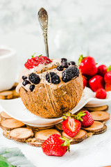 Chocolate vegan ice cream with berries on coconut cup.Selective focus. Healthy dessert concept.