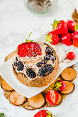 Chocolate ice cream with berries on coconut cup.