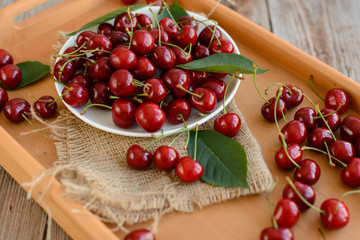 Mature berries on a plate on a wooden table