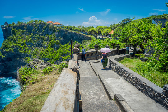 Beautiful sunny day for tourists to visit the amazing Uluwatu temple in Bali, Indonesia